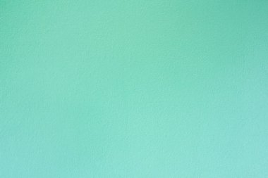 Arkaplan, doku ve kopyalama alanı için yeşil pastel çimento duvar