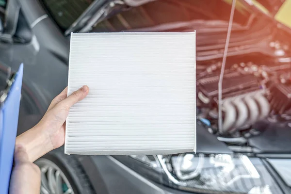 Employees women of the car service center checking filter cooling system and check list for maintenance concept of service car