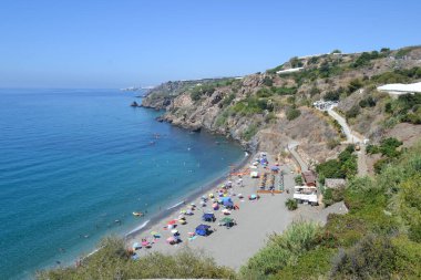 aerial photography of beach of Maro in Malaga with bathers, canoes, umbrellas and cliffs clipart
