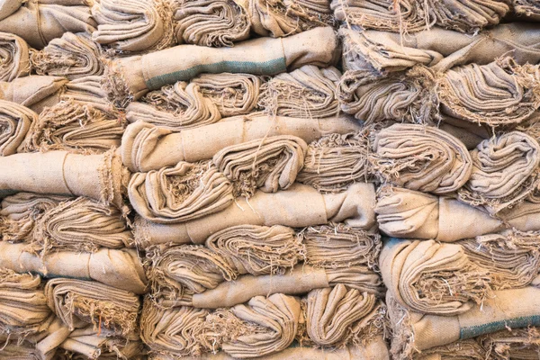 Stack of sack bags inside warehouse for packing heavy product — Stock Photo, Image