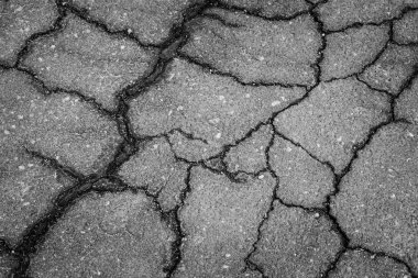 Cracked highway road with texture as black and white background clipart