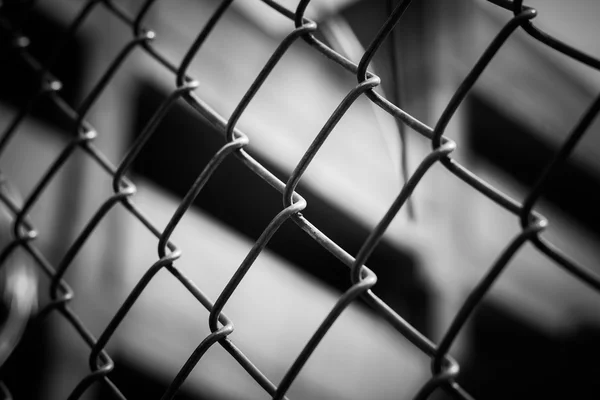 Abstract wire metal fence with blurry background — Stock Photo, Image