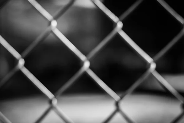 Abstract wire metal fence with blurry background — Stock Photo, Image