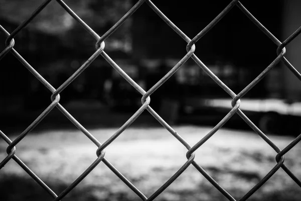 Abstract wire metal fence with blurry background — Stock Photo, Image