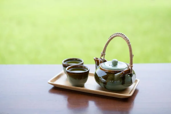 Green Brown Teapot Blurry Teacup Wooden Tray Wood Table Green — Stock Photo, Image