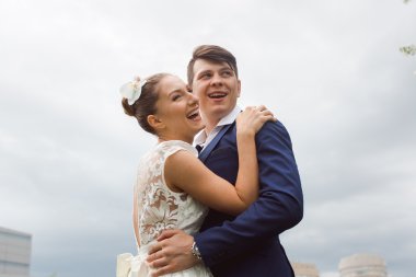 Couple hugging and laughing on the sky 