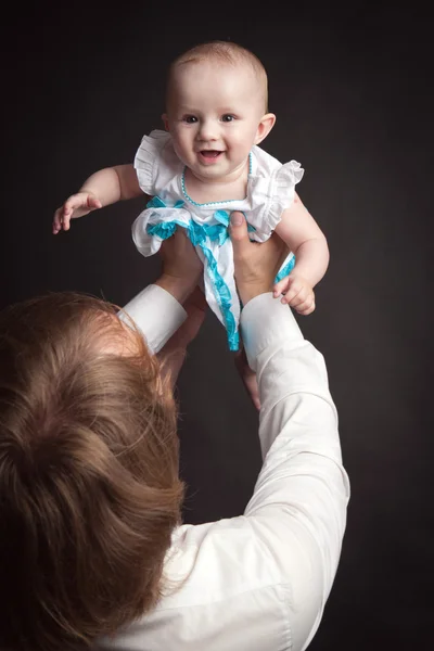 Parents hold their baby studio — Stock Photo, Image