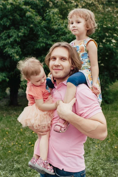 Daddy carrying children on his hands — Stock Photo, Image