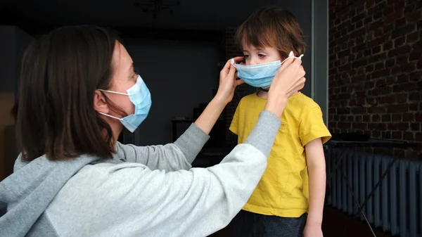 Parent puts on a protective mask on child