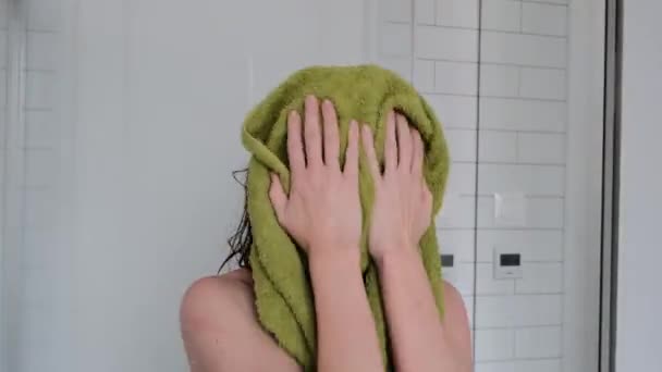 Lady wipes face and hair with towel after shower in bathroom — Stock Video