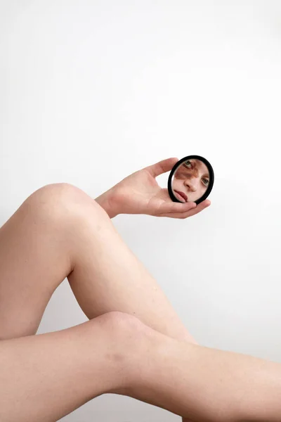 Crop model with birthmark reflecting in mirror — Stock Photo, Image