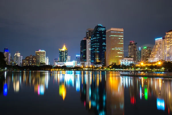 Parque Benchakitti al atardecer cerca del distrito de negocios de rascacielos — Foto de Stock