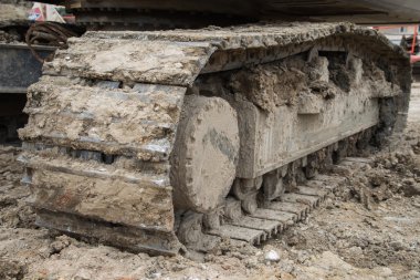 Wheel loader Excavator with backhoe unloading sand at eath works