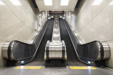 Escalator up and down in a building. clipart