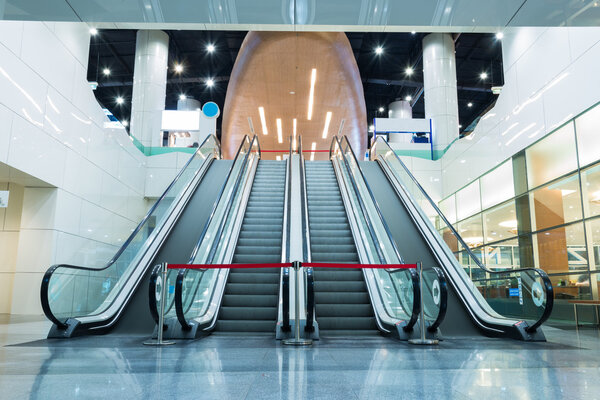 Escalator up and down in a building.