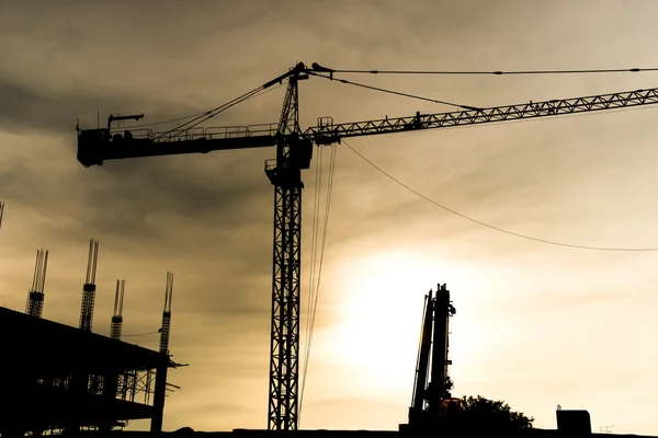 Abstract Industrial background with construction cranes silhouettes over amazing sunset sky — Stock Photo, Image