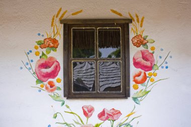 Uman, Ukraine - Jule 20, 2020: Fragment of ukranian house with a window in Park 