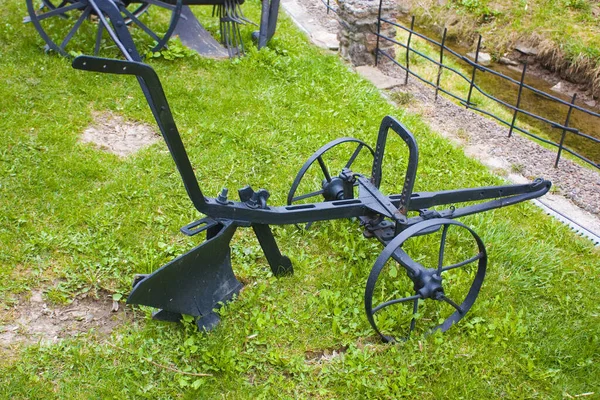 Agricultural Old Plow Front Green Grass Royalty Free Stock Images
