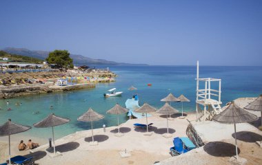 Arnavutluk 'un Ksamil kentindeki İyon Denizi' nin masmavi sularıyla dolu plaj