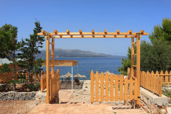 Landscape with wooden gate near beach in Ksamil, Albania