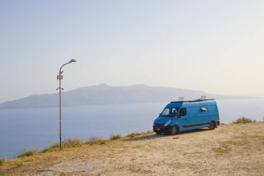 Arnavutluk 'un Saranda kentindeki tepeden Korfu Adası manzarası ve mavi karavan