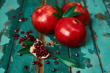Pomegranate on the old wooden background. Rustic still life. clipart