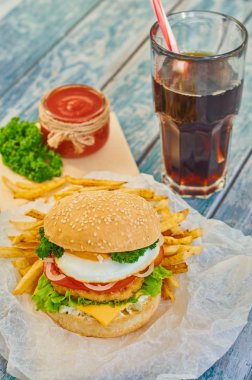 Home made burger on wooden background clipart