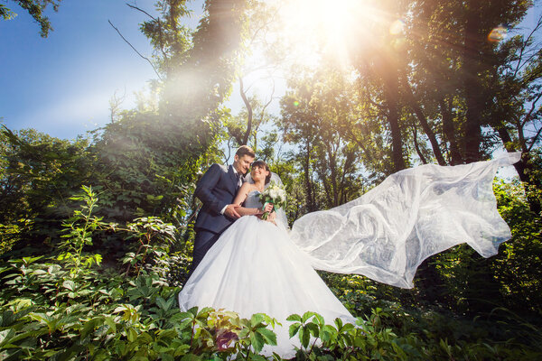Bride and groom in amazing summer green forest