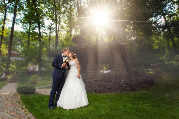 Casal beijando perto de pavillion na luz solar — Fotografia de Stock