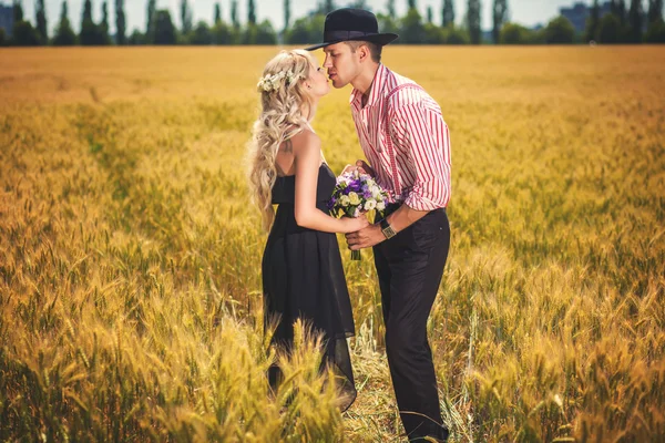 Kyssande par på vete fält — Stockfoto