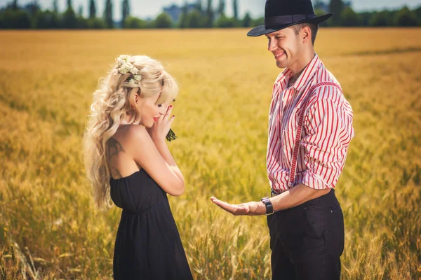 Groom showing rings to bride outdoors