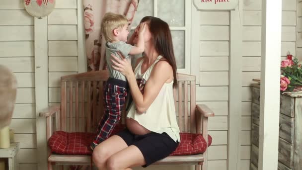 Pregnant woman playing with elder child — Stock Video