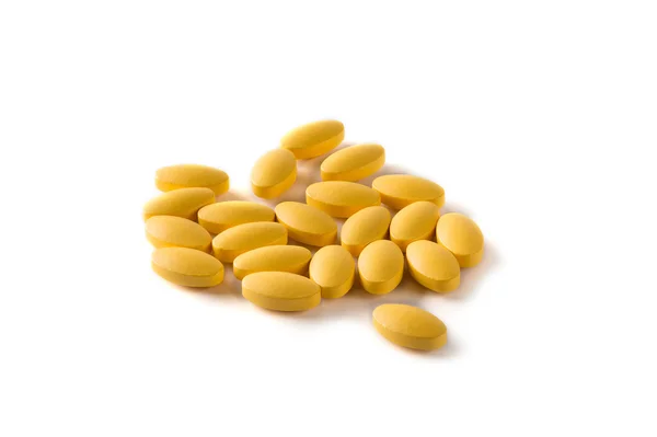 Žluté pilulky na bílém pozadí — Stock fotografie