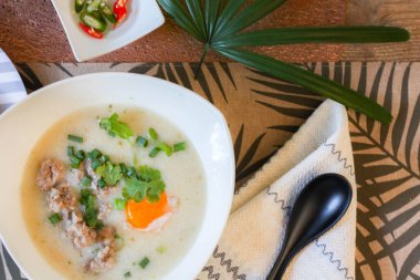 Çin usulü yulaf lapası, yulaf lapası ve kızarmış hamur çubuğu ya da kızarmış hamur çubuğu ya da çörek ya da ahşap masaya yerleştirilmiş kızarmış ekmek. Tayland sokak yemeklerine 