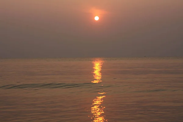 The sun is rising, the sun is bright, the morning sea at Cha-Am Beach, Thailand.