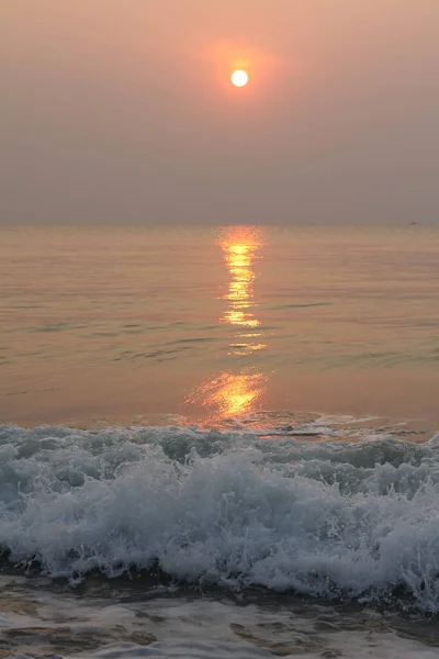 The sun is rising, the sun is bright, the morning sea at Cha-Am Beach, Thailand.