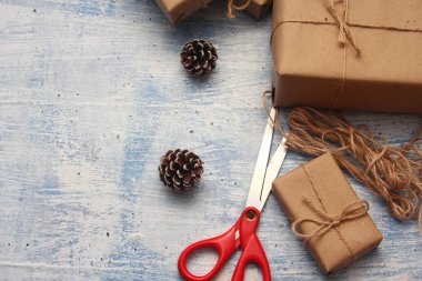 İplikle sarılmış Kraft kağıdından hediye paketi, el yapımı konsept, açık mavi masa üstü.