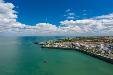 Limanın, turkuaz Atlantik suları ve dağınık bulutlarla dolu gökyüzü ile çevrili, turuncu çatıları Ile de Re 'de, Charente-Maritime' de olan beyaz boyalı evlerin geniş hava perspektifi. Sahne adaların sahil cazibesini vurguluyor, marina.