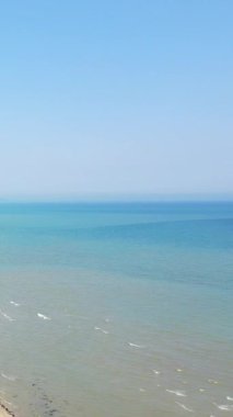 Sakin mavi deniz ve açık gökyüzü Normandiya, Fransa 'da Utah Plajı' nda. Hafif dalgalar ve sakin atmosferli minimalist kıyı manzarası.