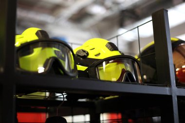 İtfaiyeciler ve kurtarma başlıkları yangın ve kurtarma istasyonunda tezgahın üzerinde..