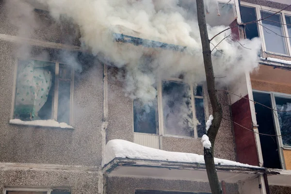 Three firefighters extinguish a fire in an apartment house