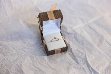 Beyaz altın taşlı bir nişan yüzüğü bir kutuda duruyor.