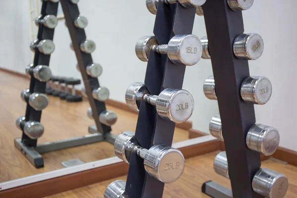 Group of dumbbell on rack in workout room — Stock Photo, Image