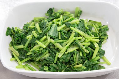 green boiled bog choy vegetable in white bowl