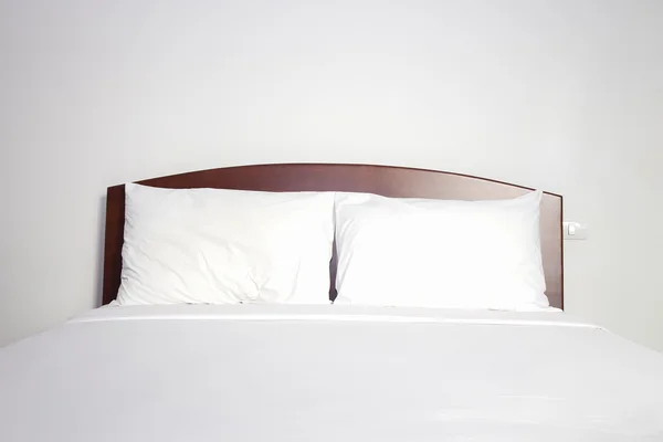 White pillow and bed in bedroom Royalty Free Stock Photos