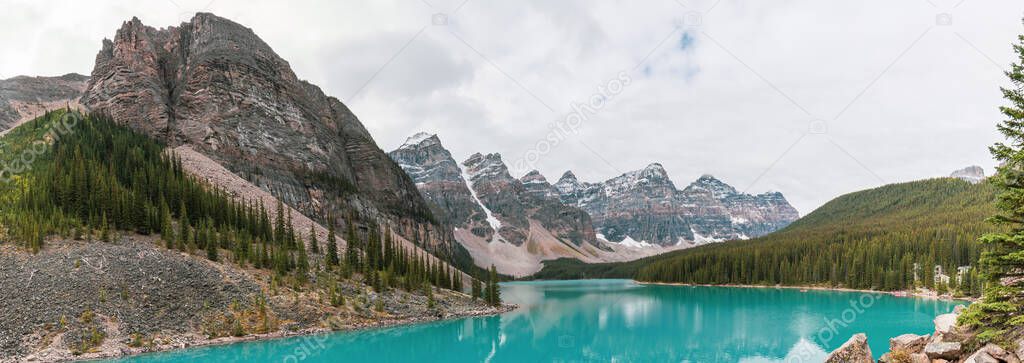 Panorama beautiful turquoise water surround with taiga forest and rocky mountain in summer morning at Moraine Lake in Banff national park of Alberta, Canada
