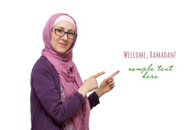 Young muslim woman pointing with her finger something, isolated  clipart