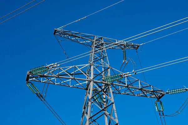 Detail of electricity pylon against blue sky Stock Picture