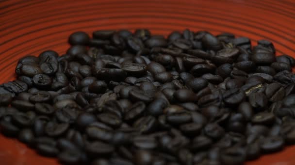 Grains of Coffee Close Up Rotating on a Red Plate — Stock Video