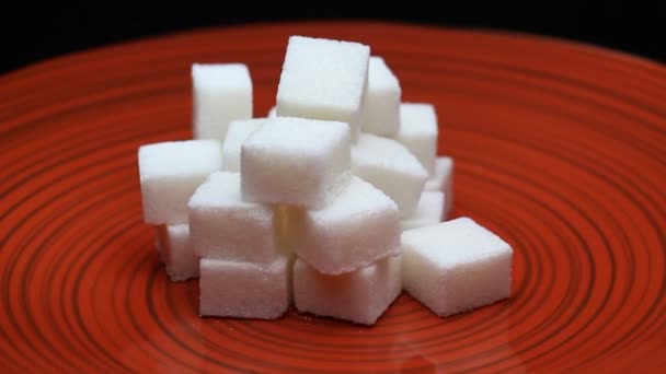 Sugar Cubes on a Red Plate Rotating — Stock Video